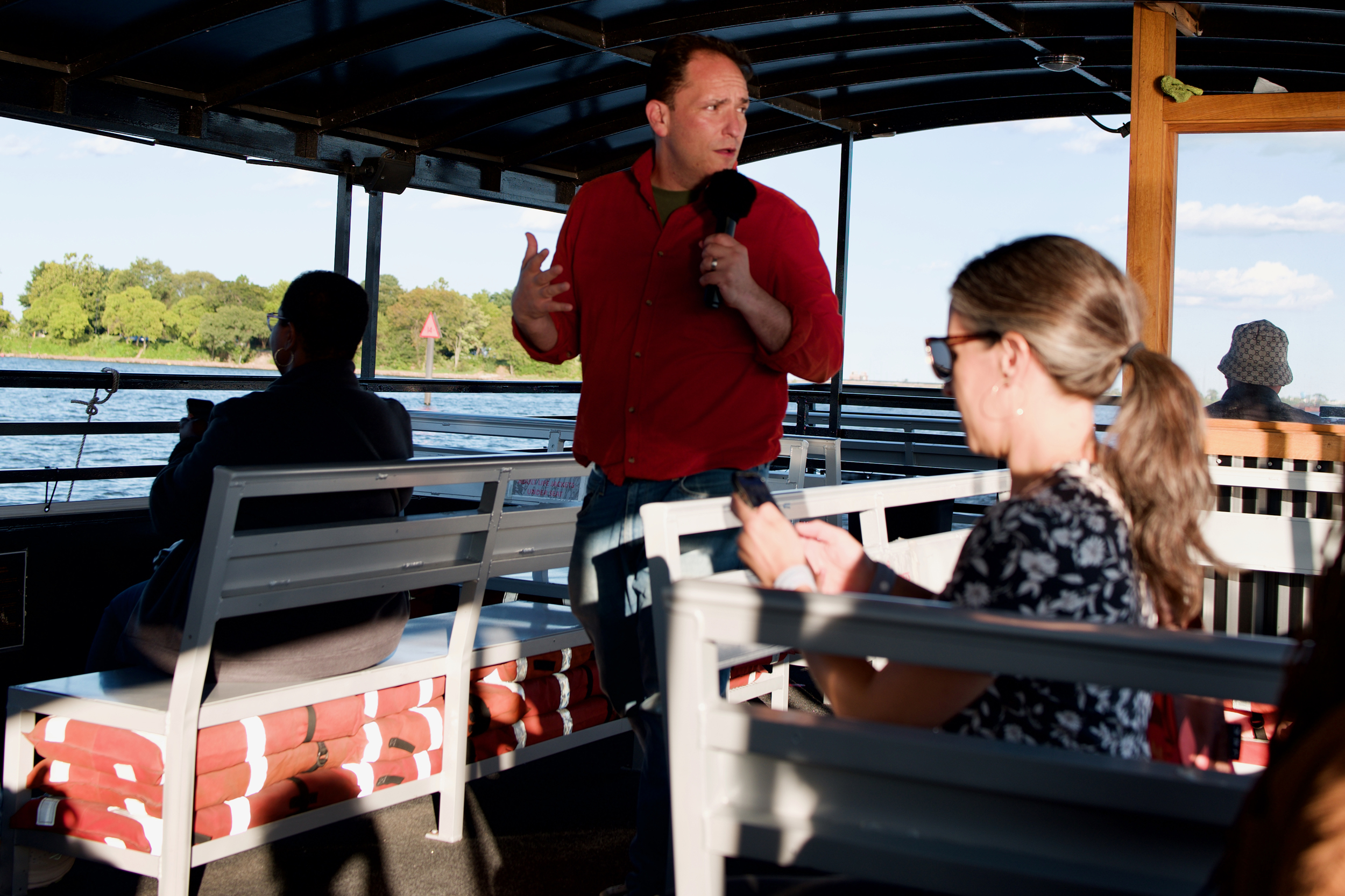 Brad Rogers briefs guests and members of South Baltimore Gateway Partnership's board of governors about the progress on wetlands restoration during a boat visit to the site. Credit: Aman Azhar/Inside Climate News