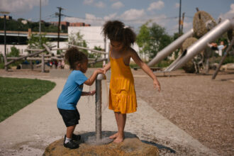 Tyrik Jr., 3, and Naylani Davis, 6, play with a water fountain at ResilienCity Park on Aug. 27 in Hoboken, New Jersey.